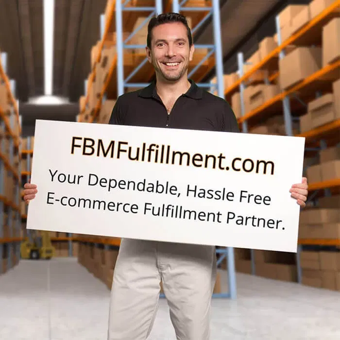 team-member-smiling-warehouse-fbmfulfillment-sign