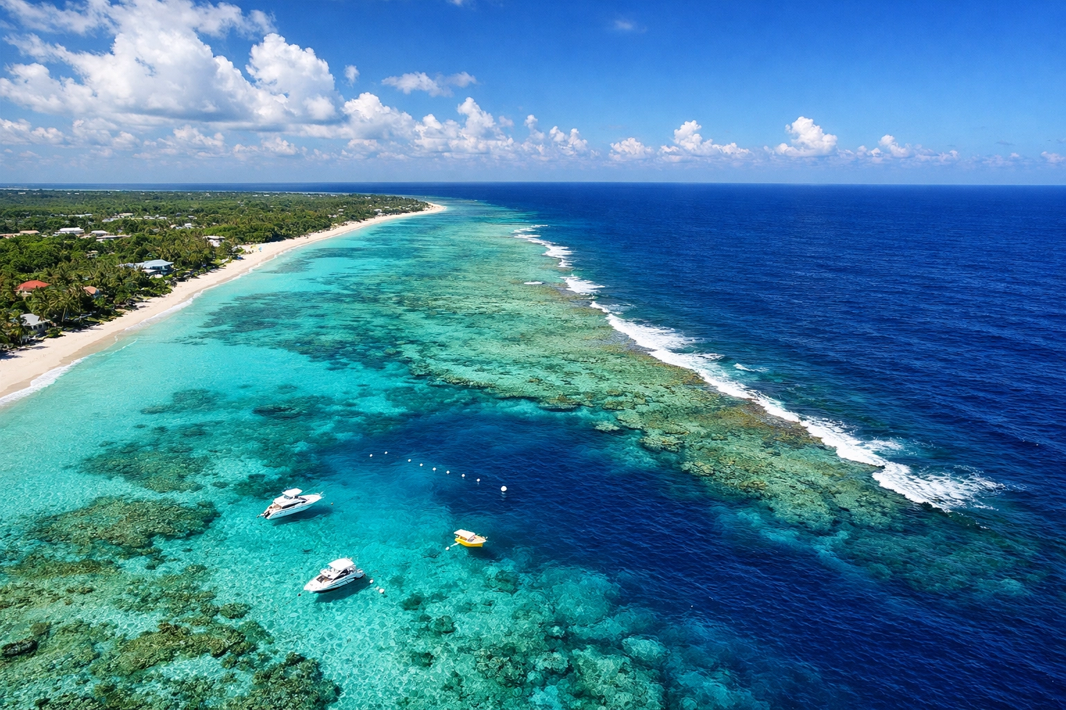 Aerial view of Cayman Islands coastline showing pristine coral reef waters and marine protected areas