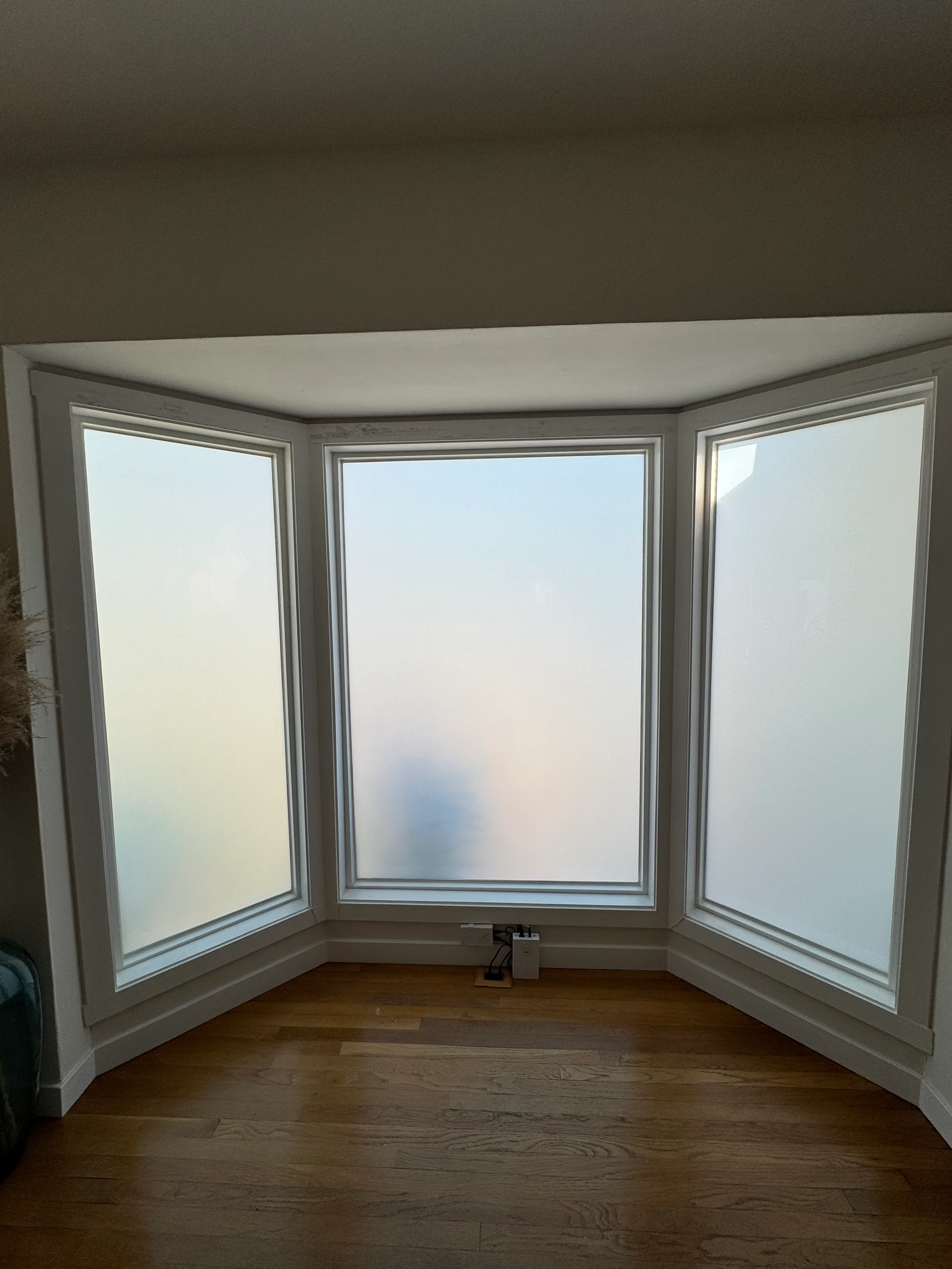 Three-panel bay window installed with Smart View smart film in frosted mode, providing instant privacy and UV protection.