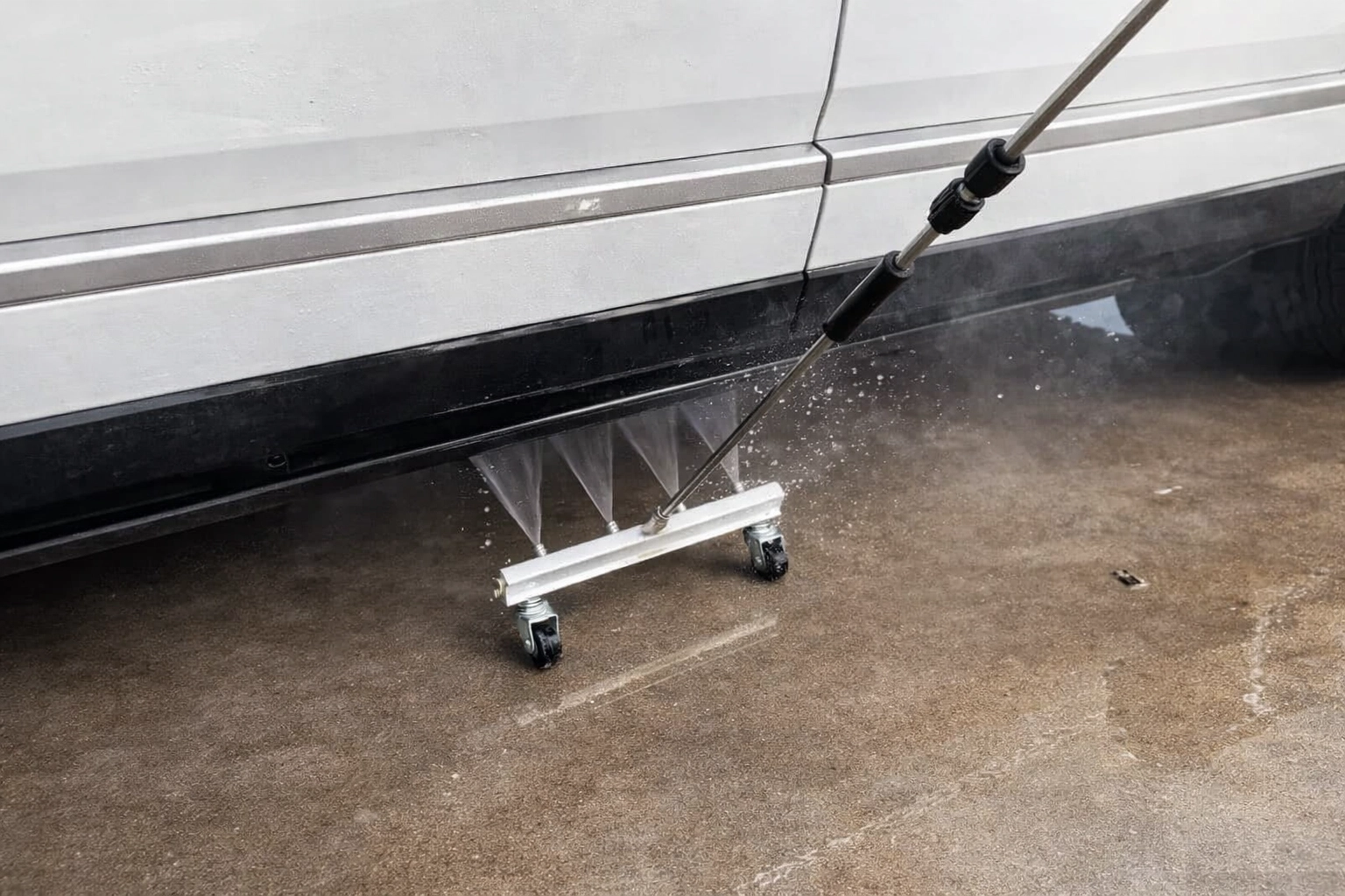 Undercarriage cleaning attachment in action used by Tay’s Auto Detailing to remove salt that standard car washes miss.