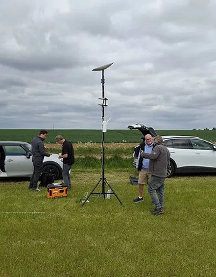 Commsuk engineers setting up a portable satellite internet dish