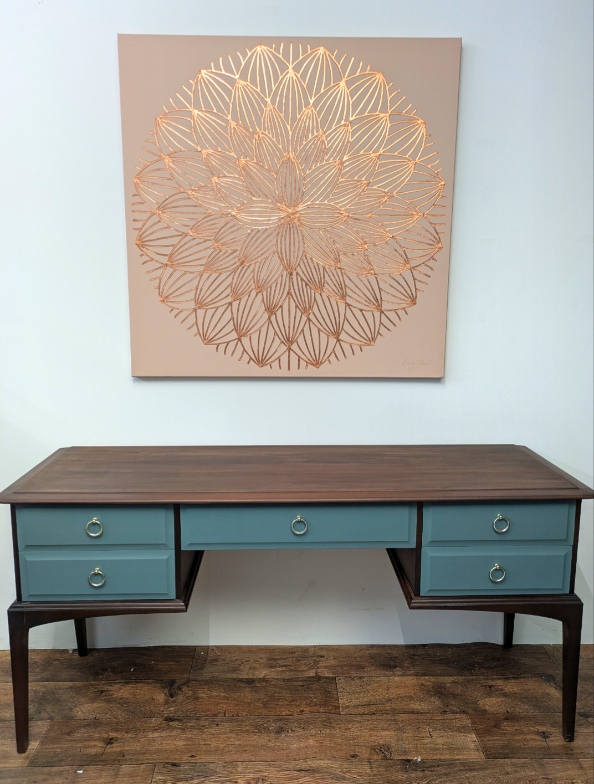 Teal and dark wood Stag-style desk/dressing table with mandala art detailing.