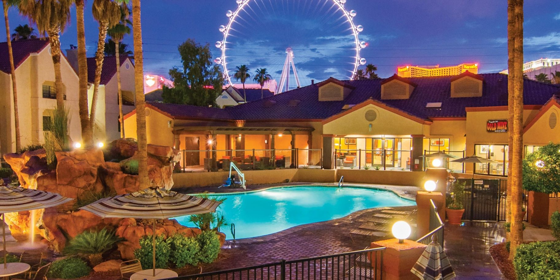 Las Vegas resort pool at night with Ferris wheel in background