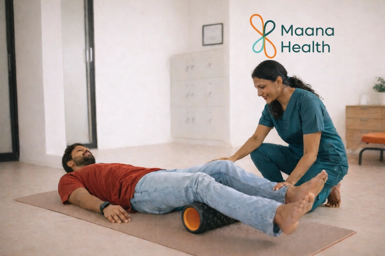 A patient using a foam roller under their legs for myofascial release with a physical therapist