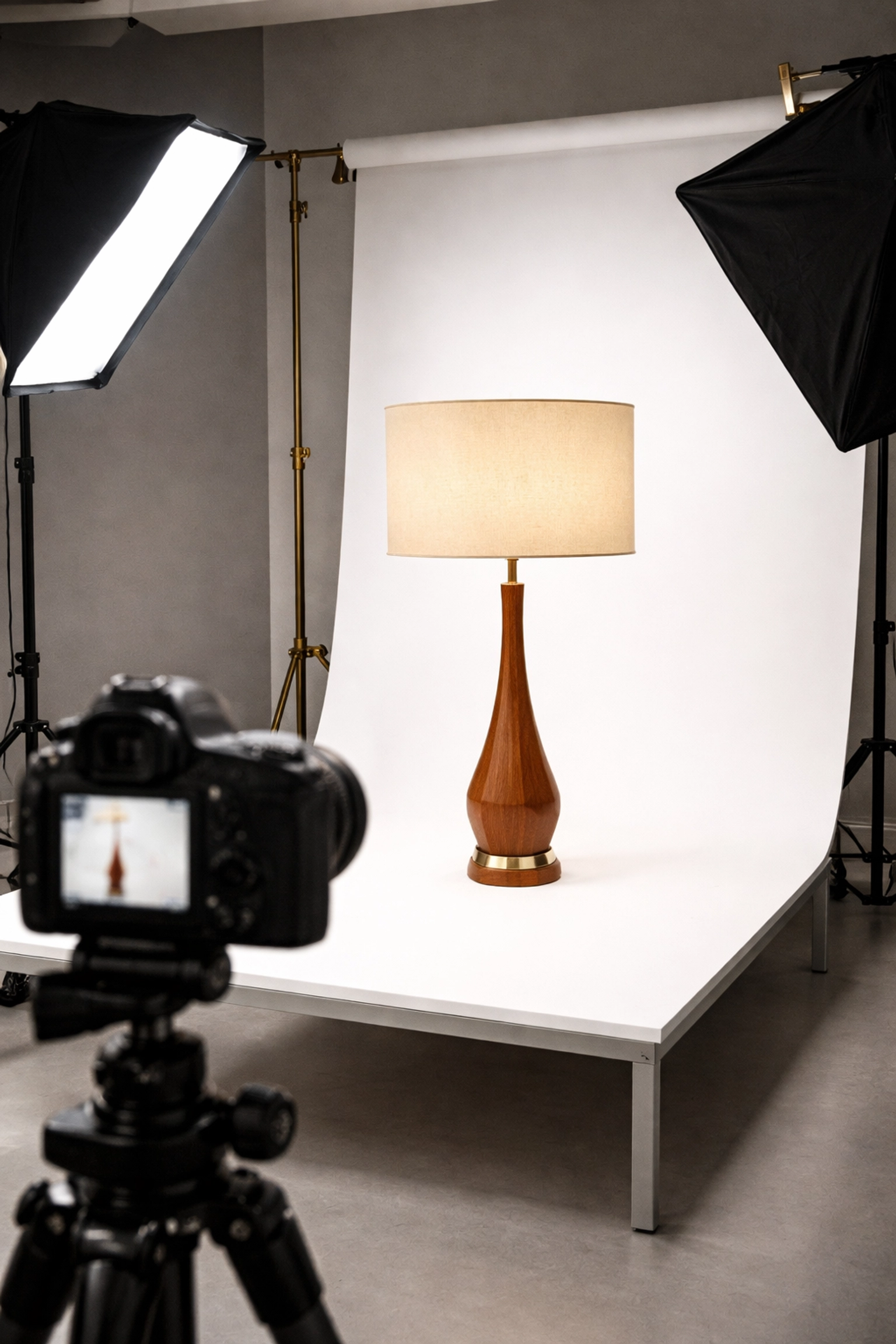 Professional photography setup highlights estate auction items with proper lighting for online sales.