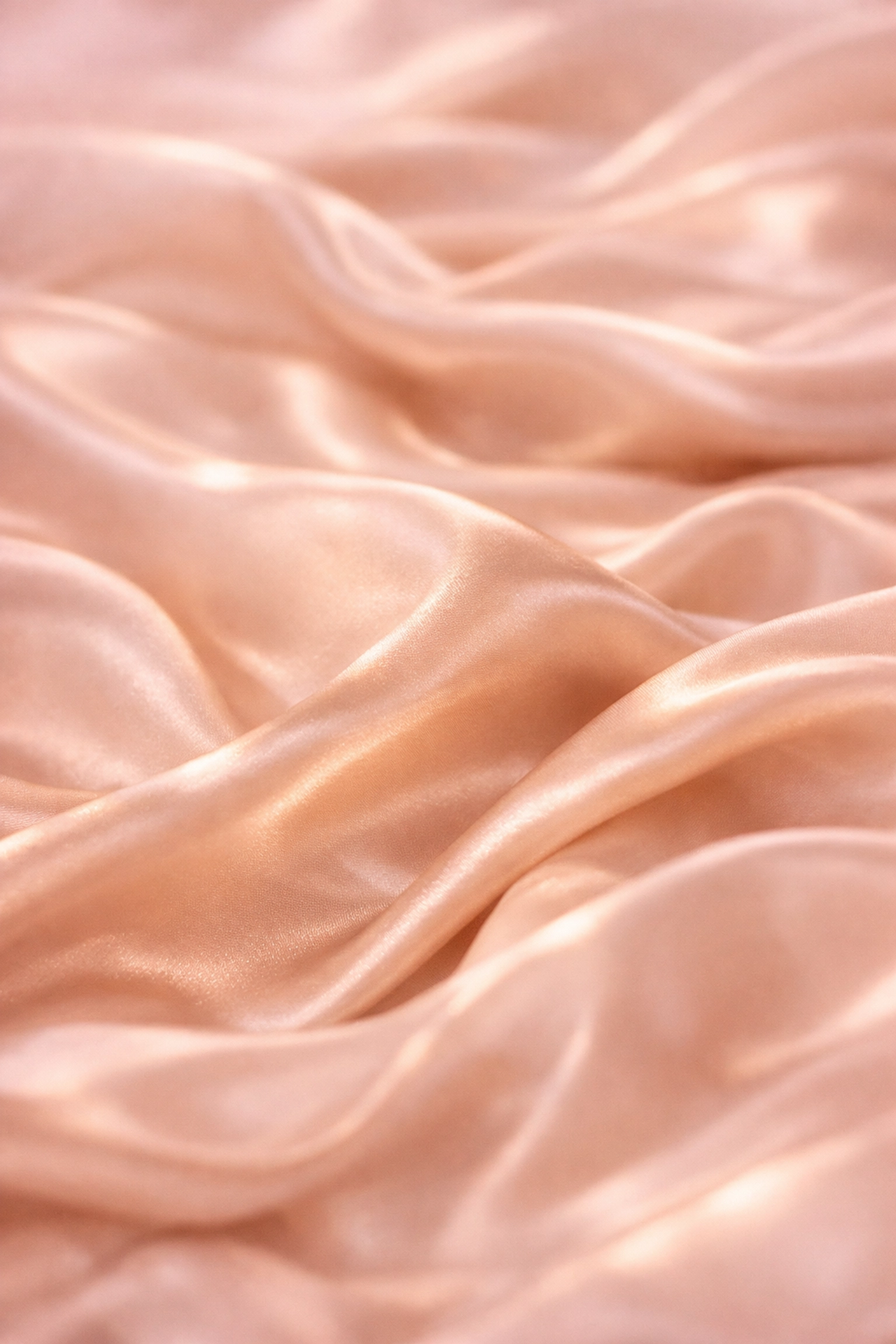 Luxurious champagne satin bedding with soft folds perfect for Valentine's Day romance