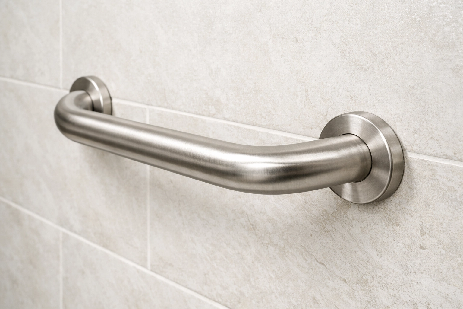 A sturdy metal grab bar installed on a bathroom wall to provide balance and prevent slips.