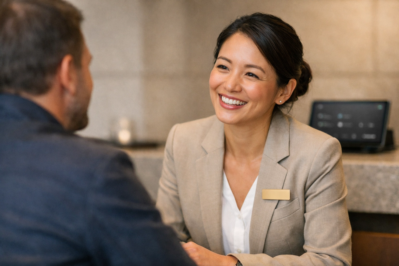 Hotel staff engaging with a guest, highlighting how invisible technology empowers human connection in hospitality.
