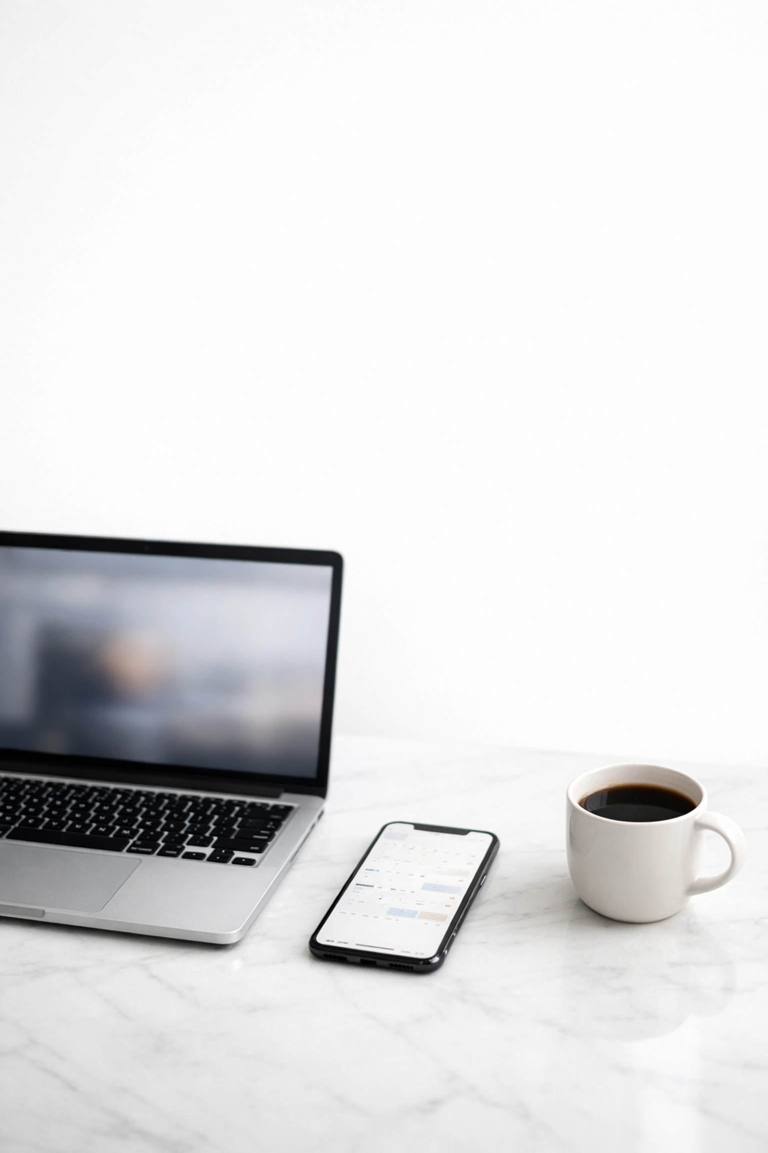 Executive workspace with laptop and calendar for meeting preparation