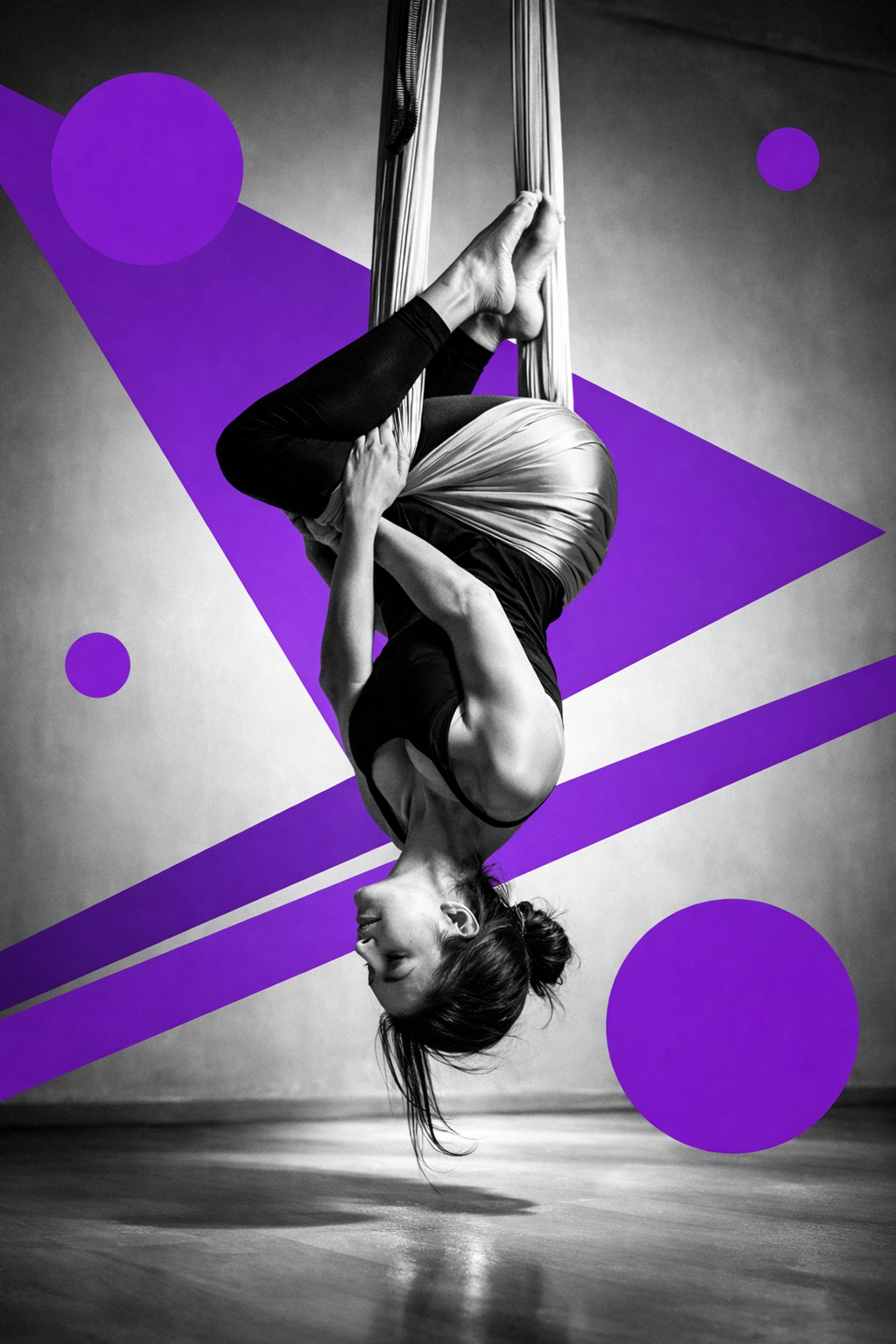 Aerial yoga student inverted in hammock at Houston yoga studio