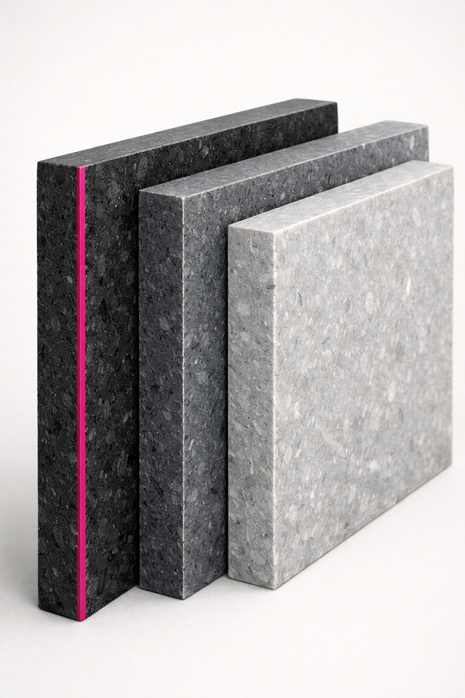 Stacked modular recycled plastic panels in grey tones showing durable texture for custom event fixtures.