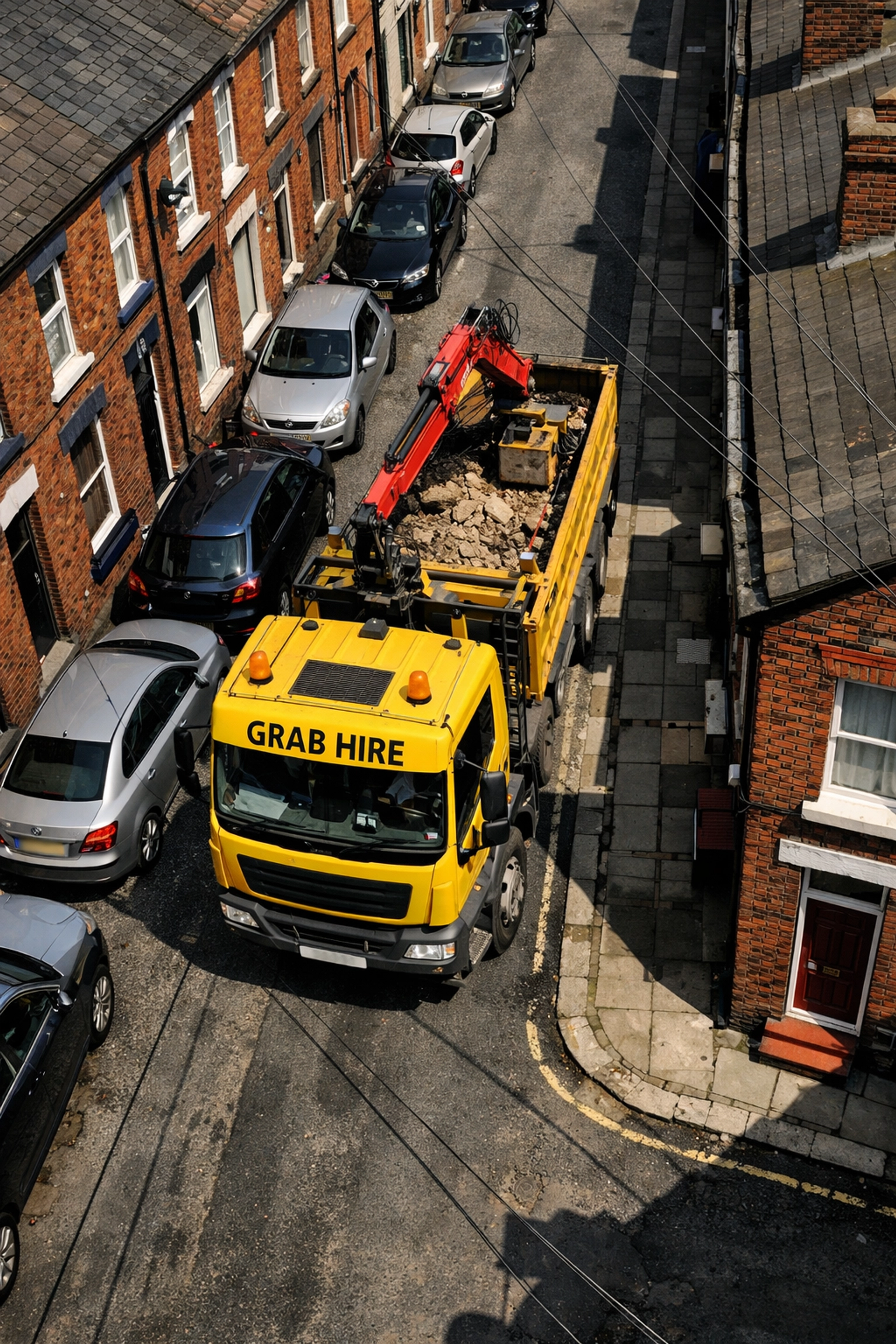 Grab hire lorry navigating narrow Liverpool terraced street demonstrating site access requirements
