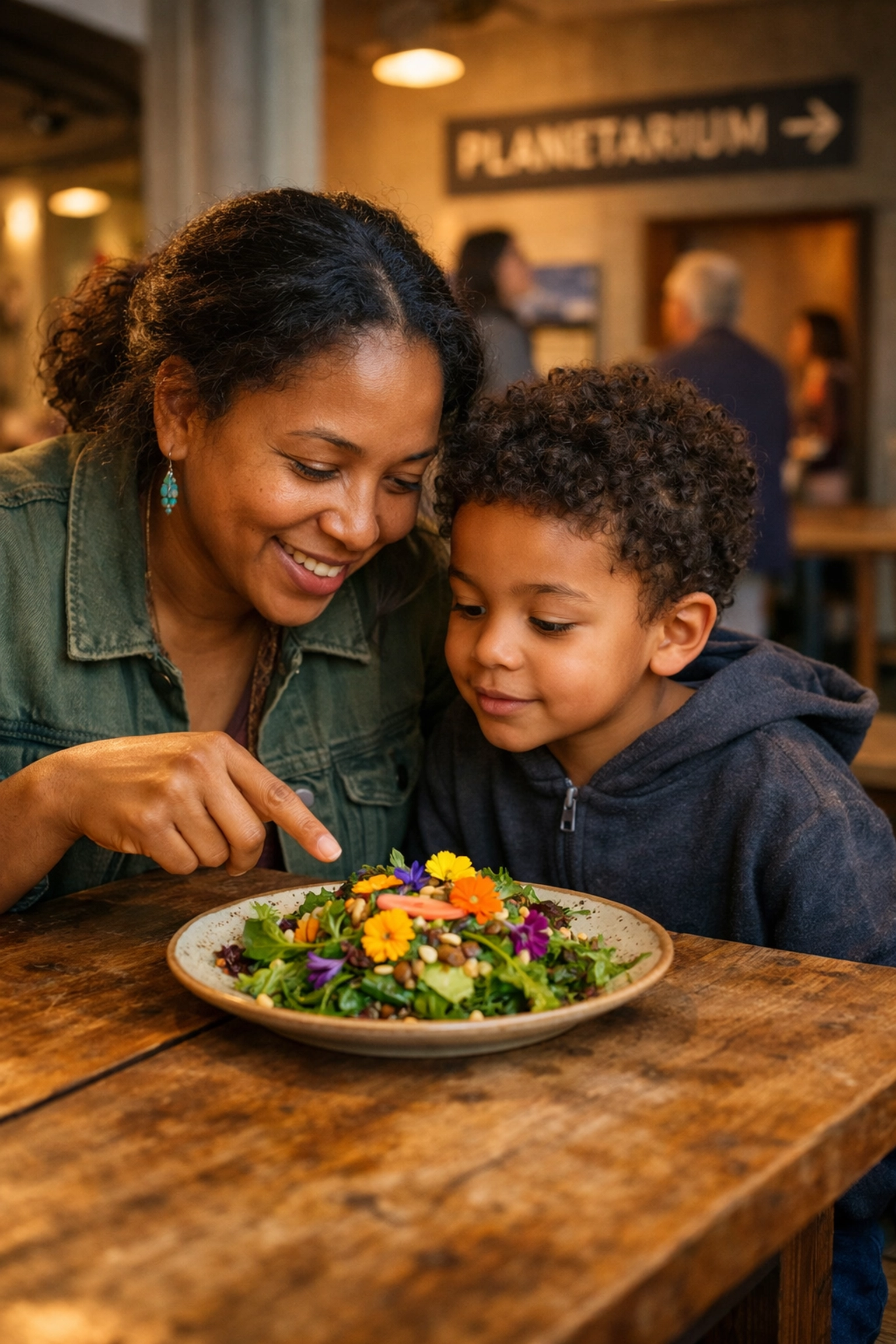 Mother and child sharing an Ohlone salad at ammatka, illustrating mission-driven institutional dining in Berkeley.