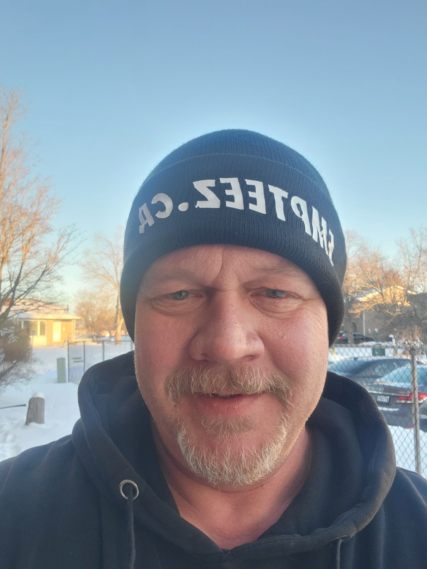 Man in Empteez.ca winter apparel out in the snow with Empteez-branded bags packed with aluminum cans