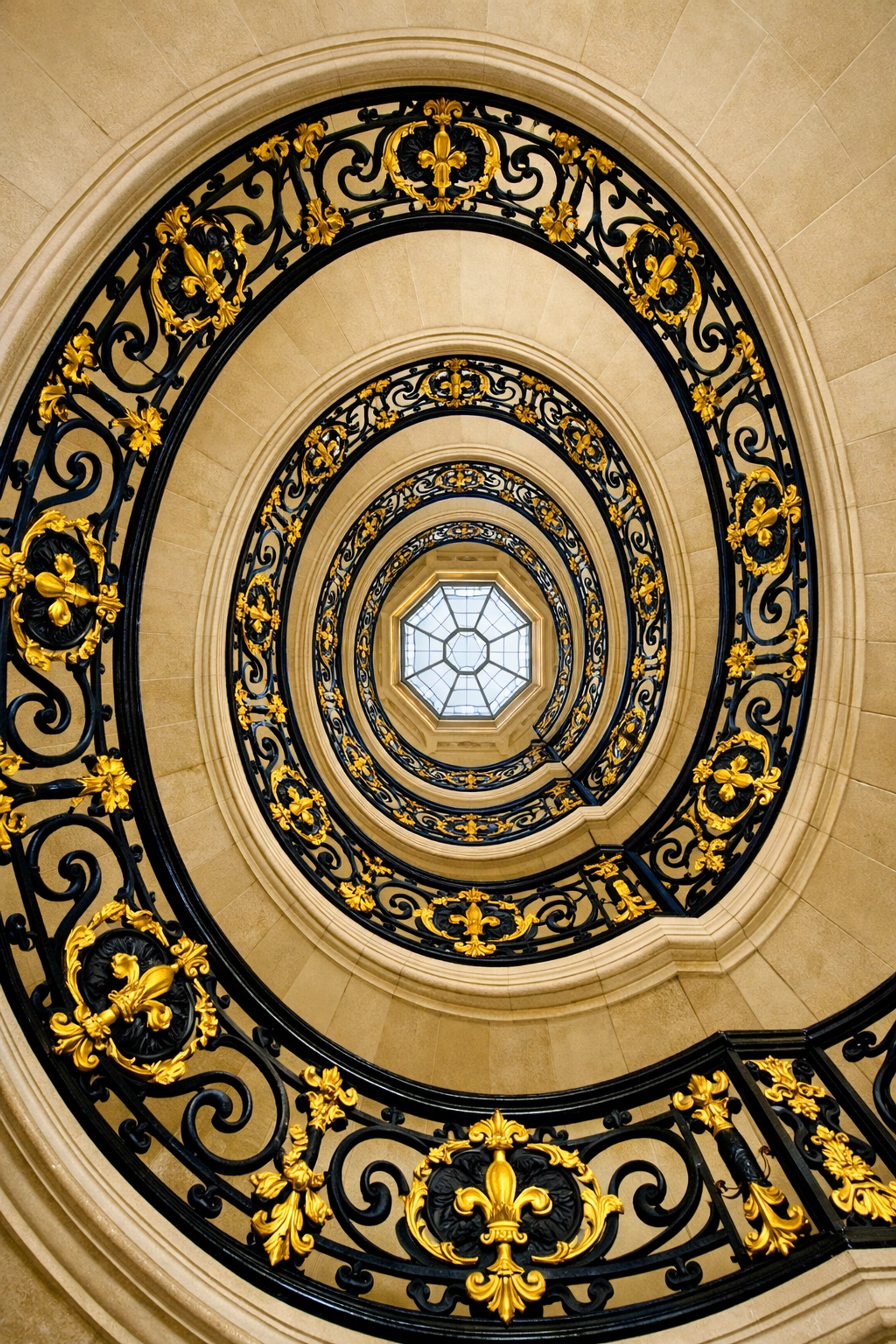Symmetrical spiral staircase with gold wrought-iron railings at the Petit Trianon, Versailles.