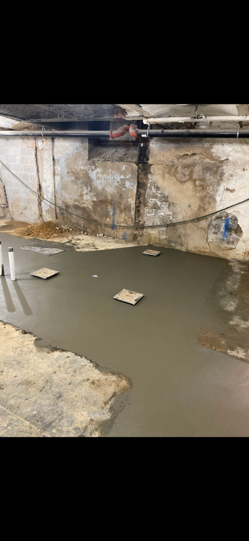 Basement renovation prep showing concrete cutting for plumbing access