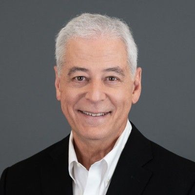 Mature man in black suit representing a legacy of service and industry leadership.