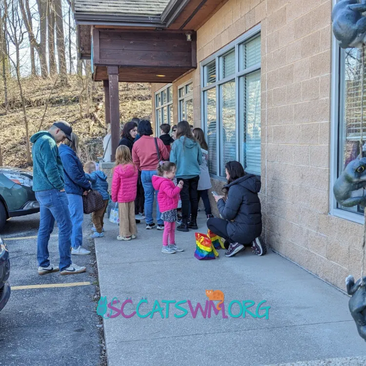 Families and individuals waiting in line outside Second Chance Cats of West Michigan.