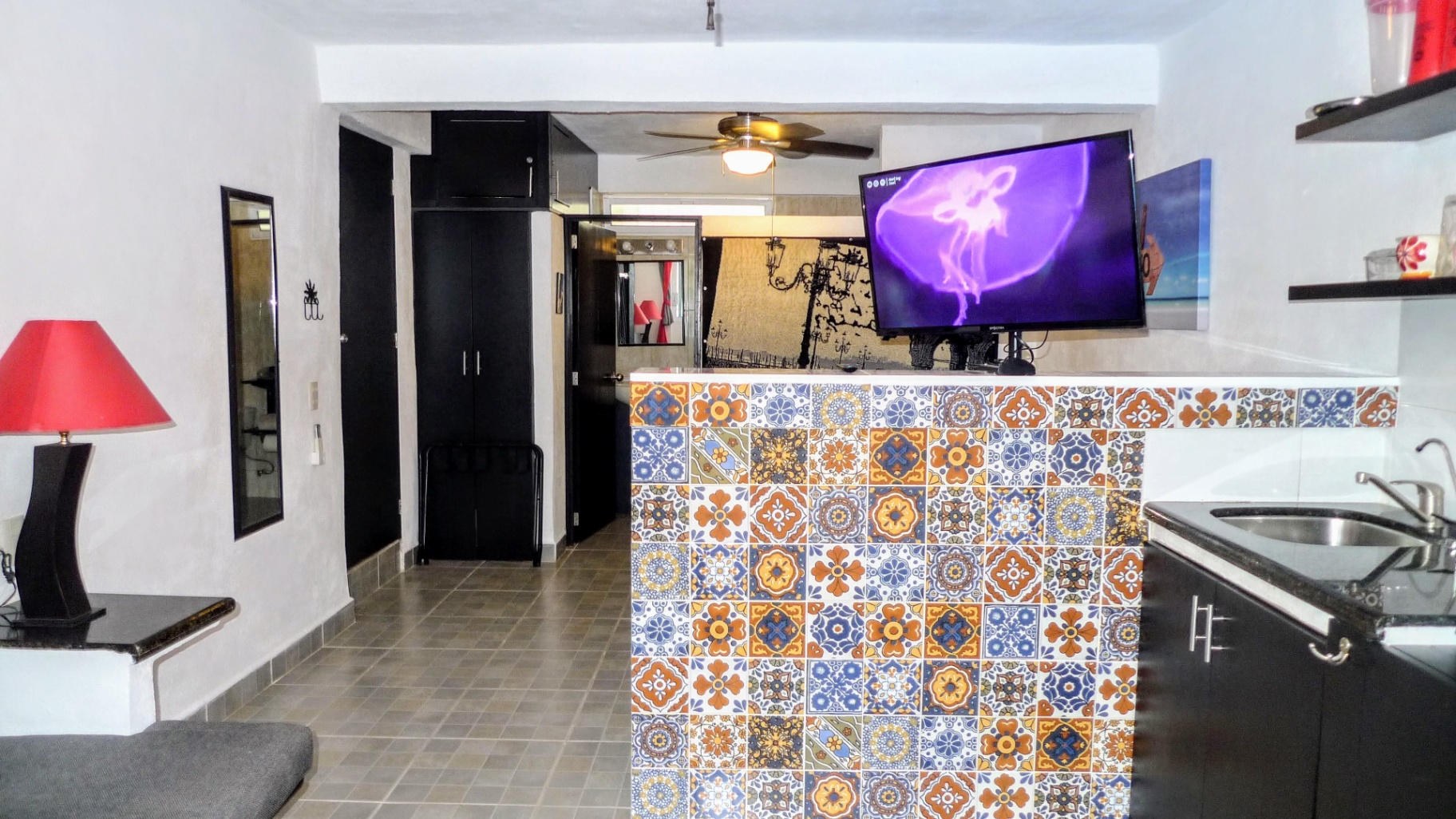 Modern Puerto Vallarta condo featuring a colorful Mexican tile breakfast bar and open-concept living space.