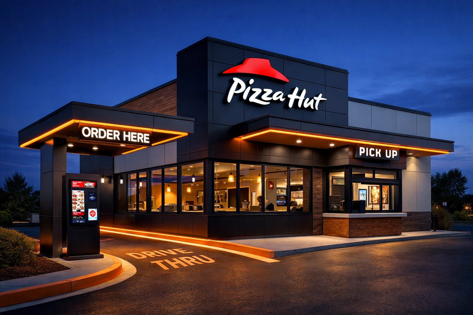 Modern Pizza Hut restaurant with drive-thru and digital ordering kiosks at dusk