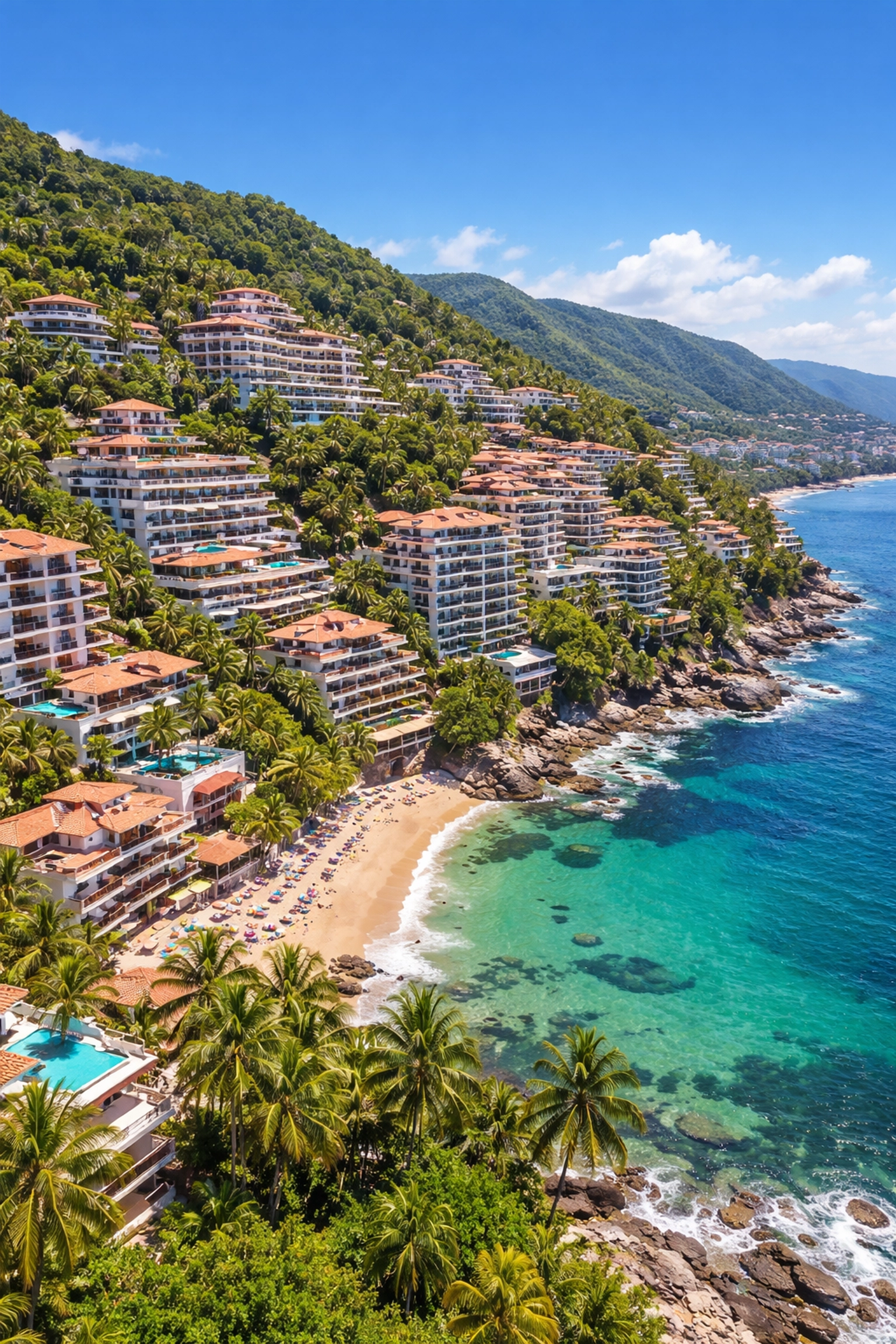 Aerial view of Amapas neighborhood condos surrounded by lush green hills and Pacific Ocean in Puerto Vallarta
