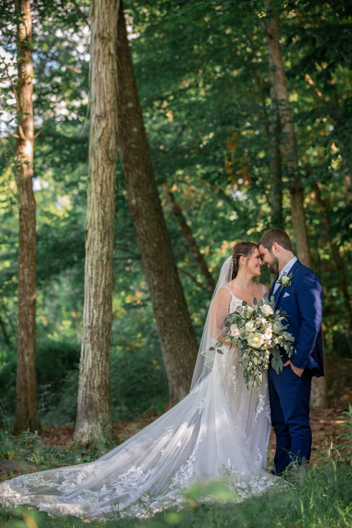Close-up of Samantha and Tyler sharing an intimate moment in the sunlit forest