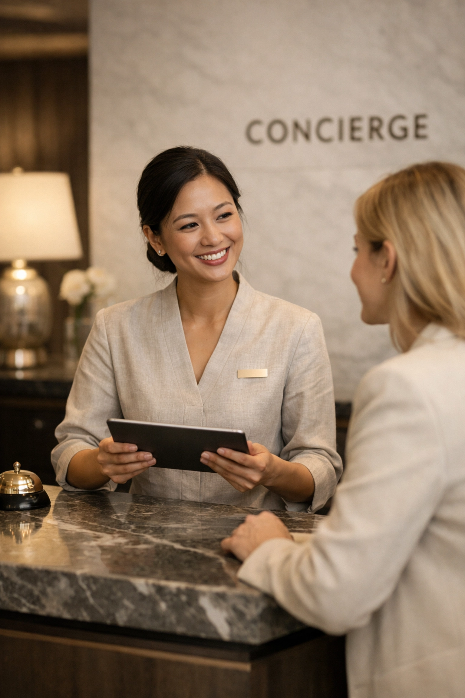 Hotel staff using a unified CRM on a tablet for a personalized and fast guest check-in experience.