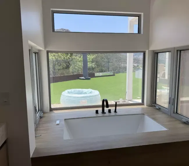 Modern bathroom with large windows and soaking tub