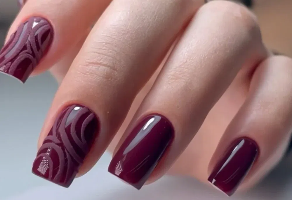 Elegant square-shaped nails featuring a rich burgundy Shellac with wave-texture art