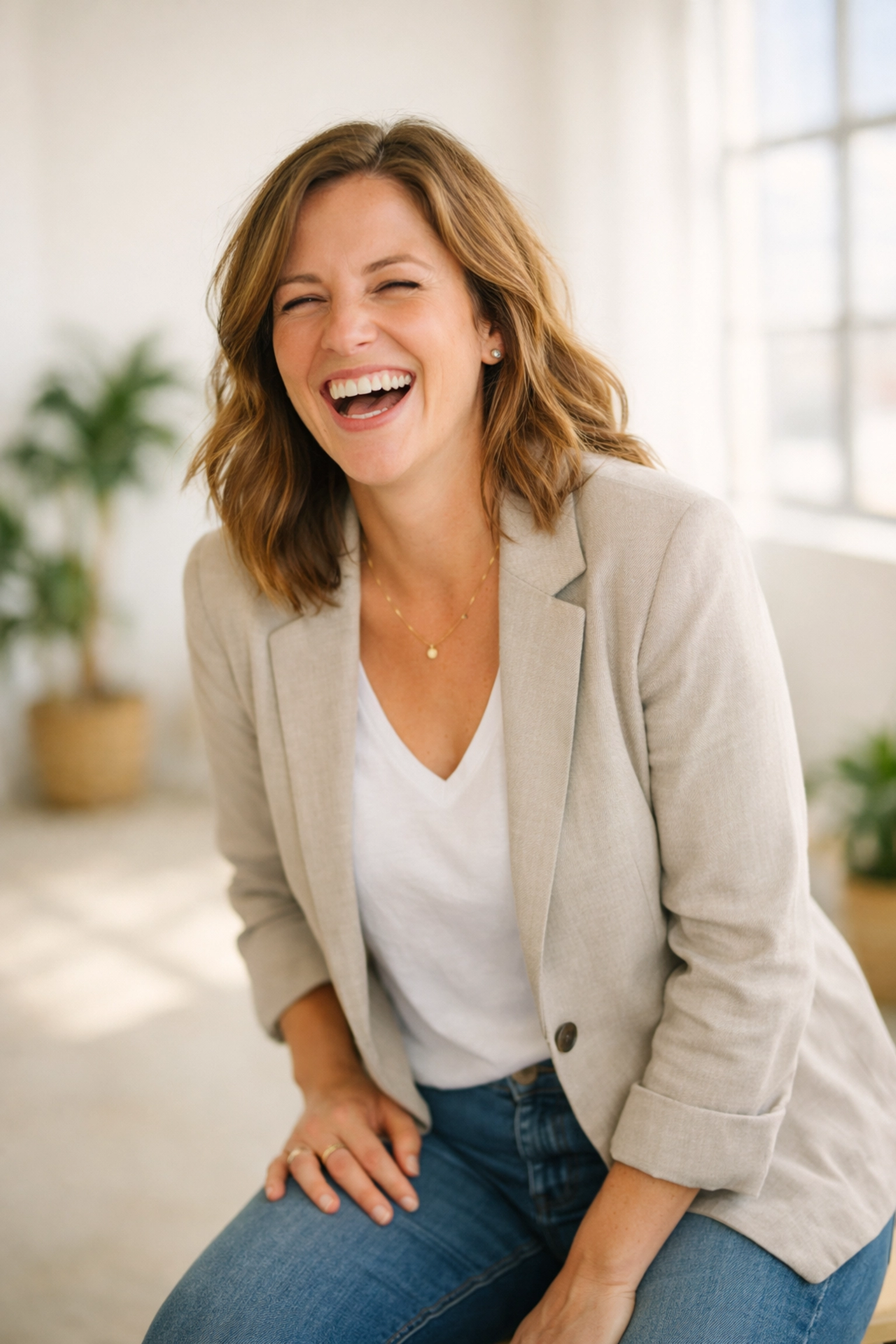 Female business owner laughing during authentic brand photoshoot in Denver studio