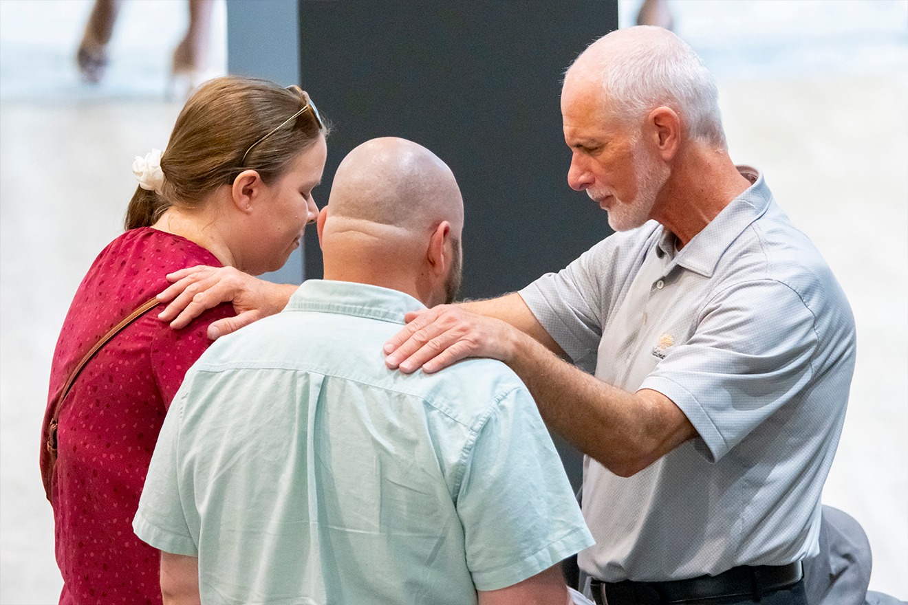 Connection Team Praying with Guests