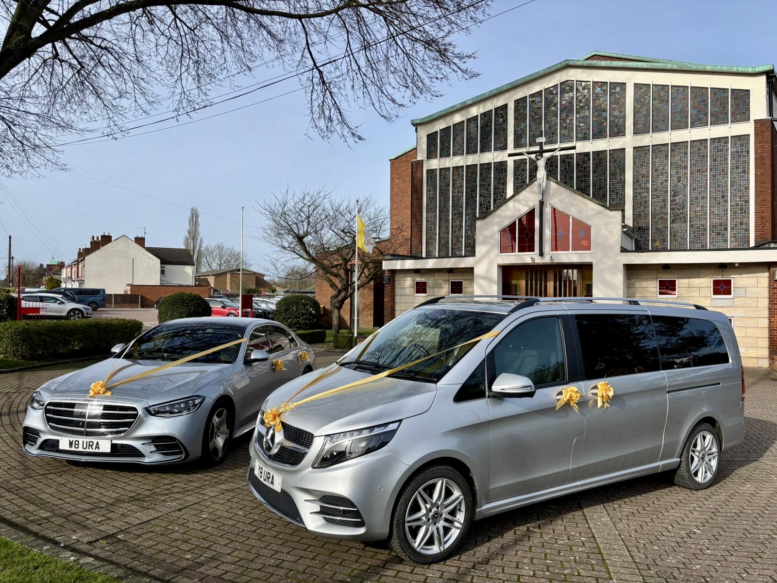 Two silver Mercedes-Benz wedding cars
