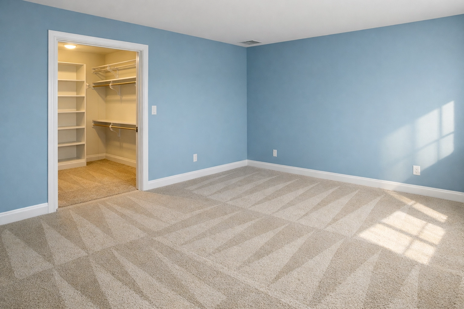 Clean empty bedroom with professional vacuum lines on the carpet after a thorough move-in deep cleaning.