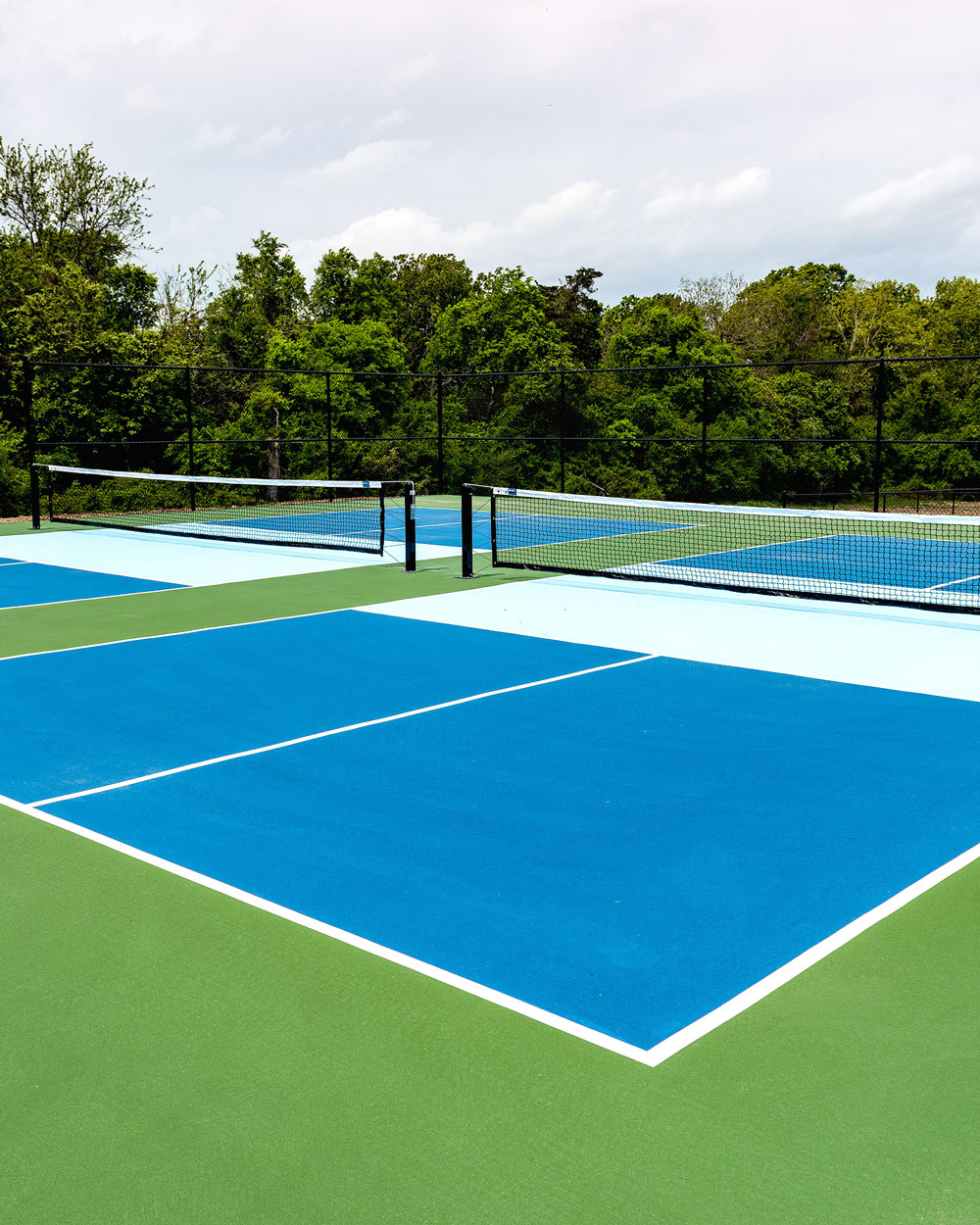 Newly constructed outdoor pickleball courts by Sportscapers showing professional-grade finishing