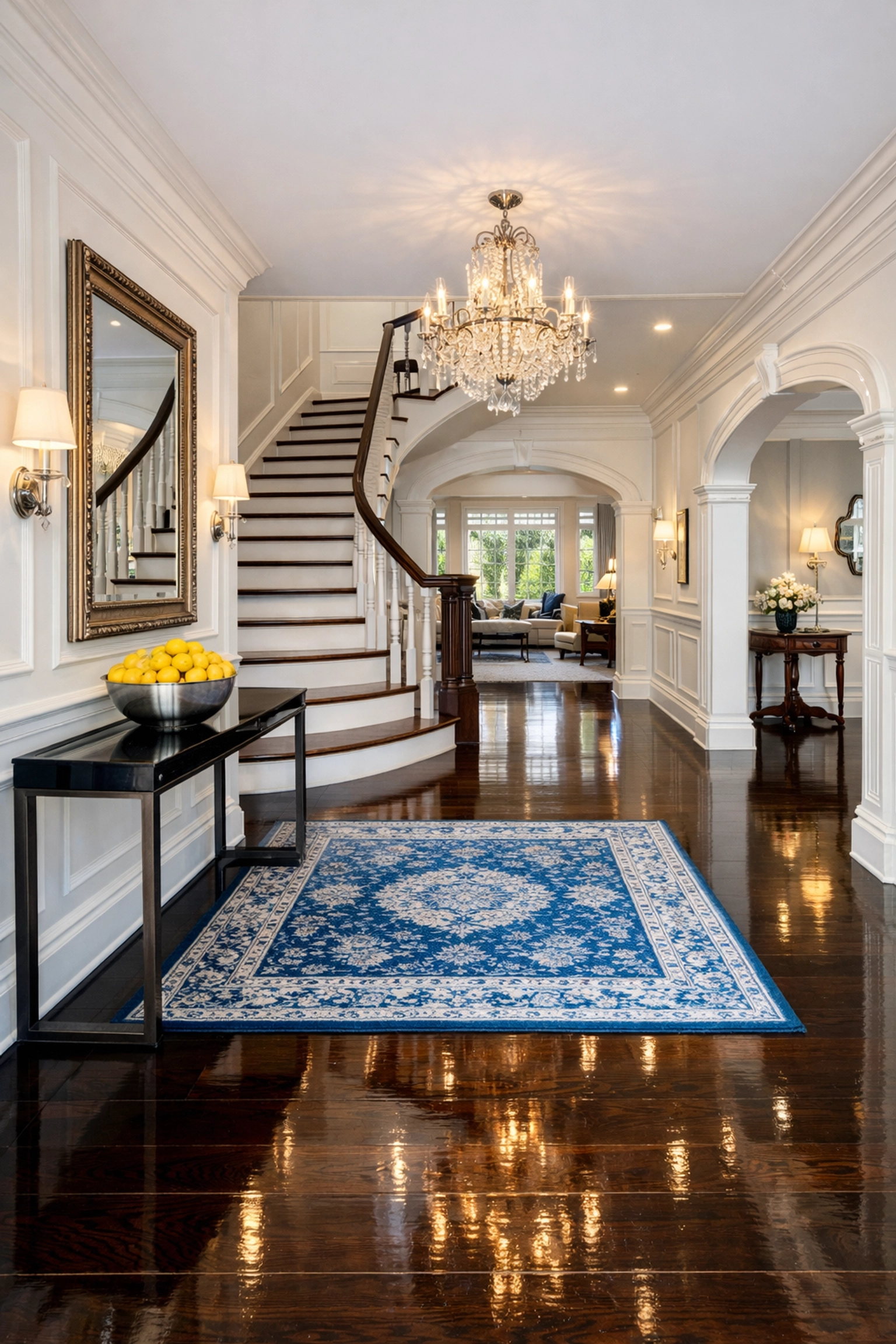 High-gloss polished hardwood floors in a grand Newton entryway following a luxury residential clean.