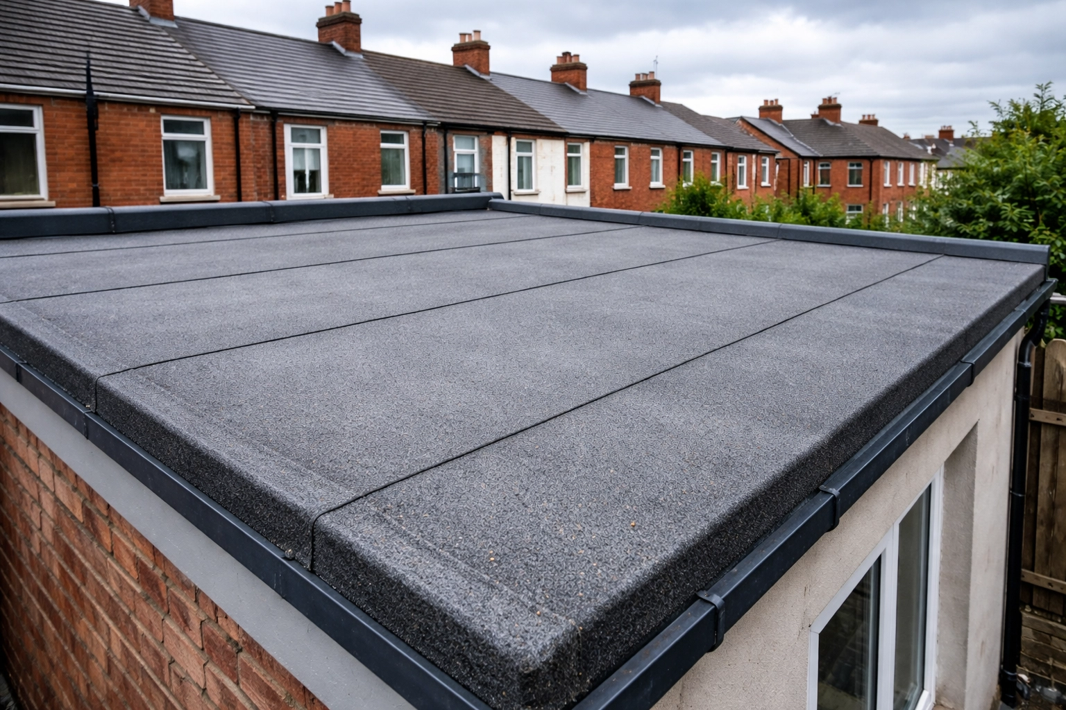 Traditional felt flat roof on a Belfast extension, showing visible seams and typical weathering