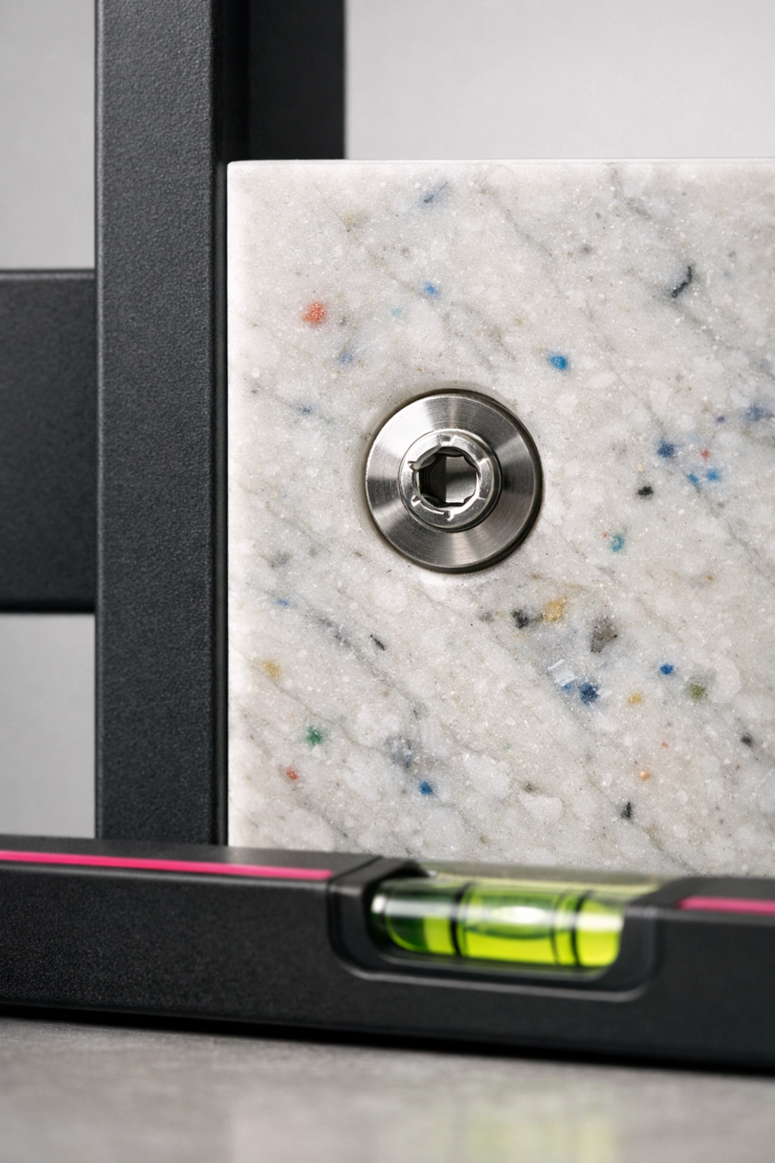 Recycled plastic panel bolted to a frame, illustrating design for disassembly in circular construction.