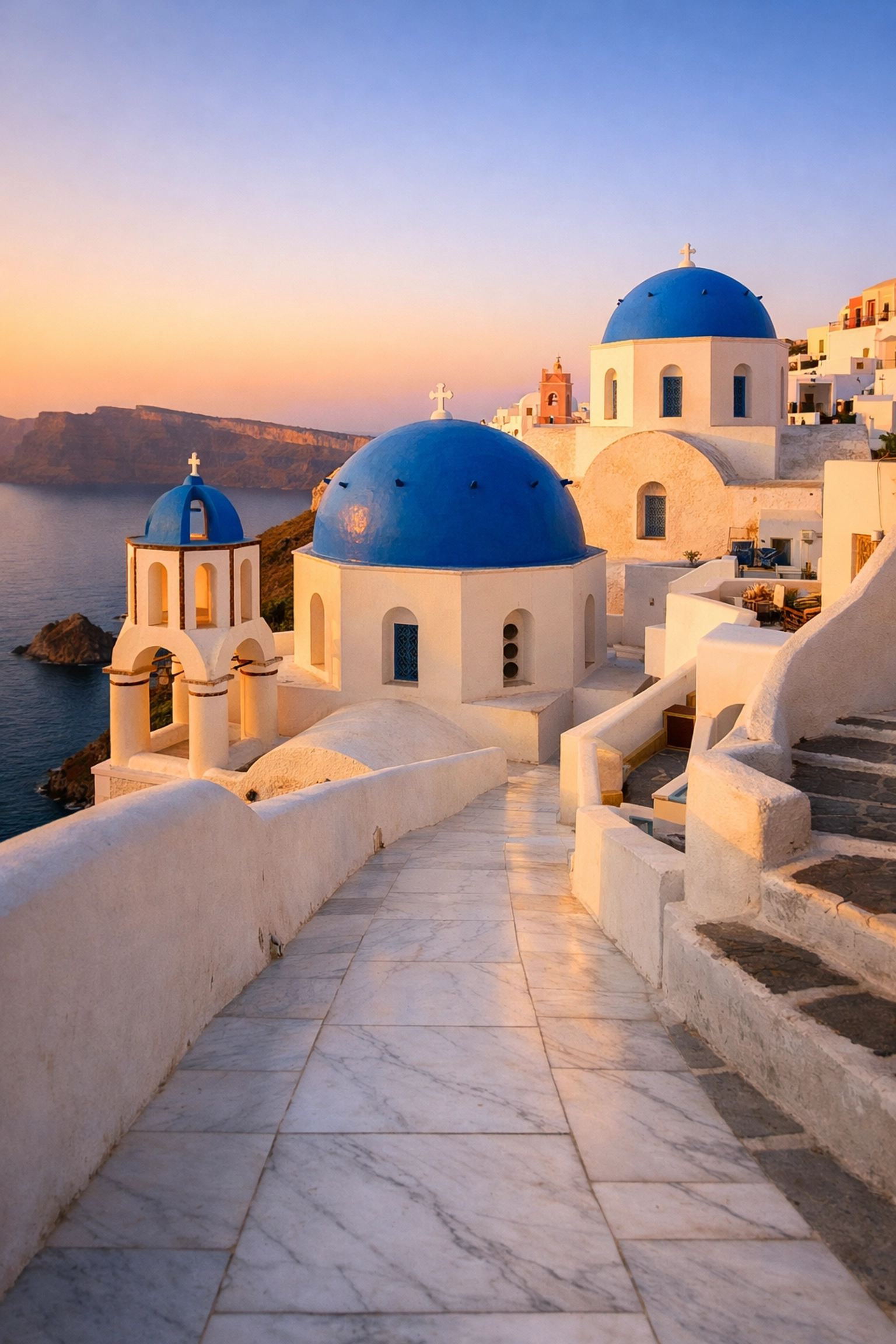 Iconic blue-domed churches of Santorini at sunset, known as one of the most instagrammable places in the world.