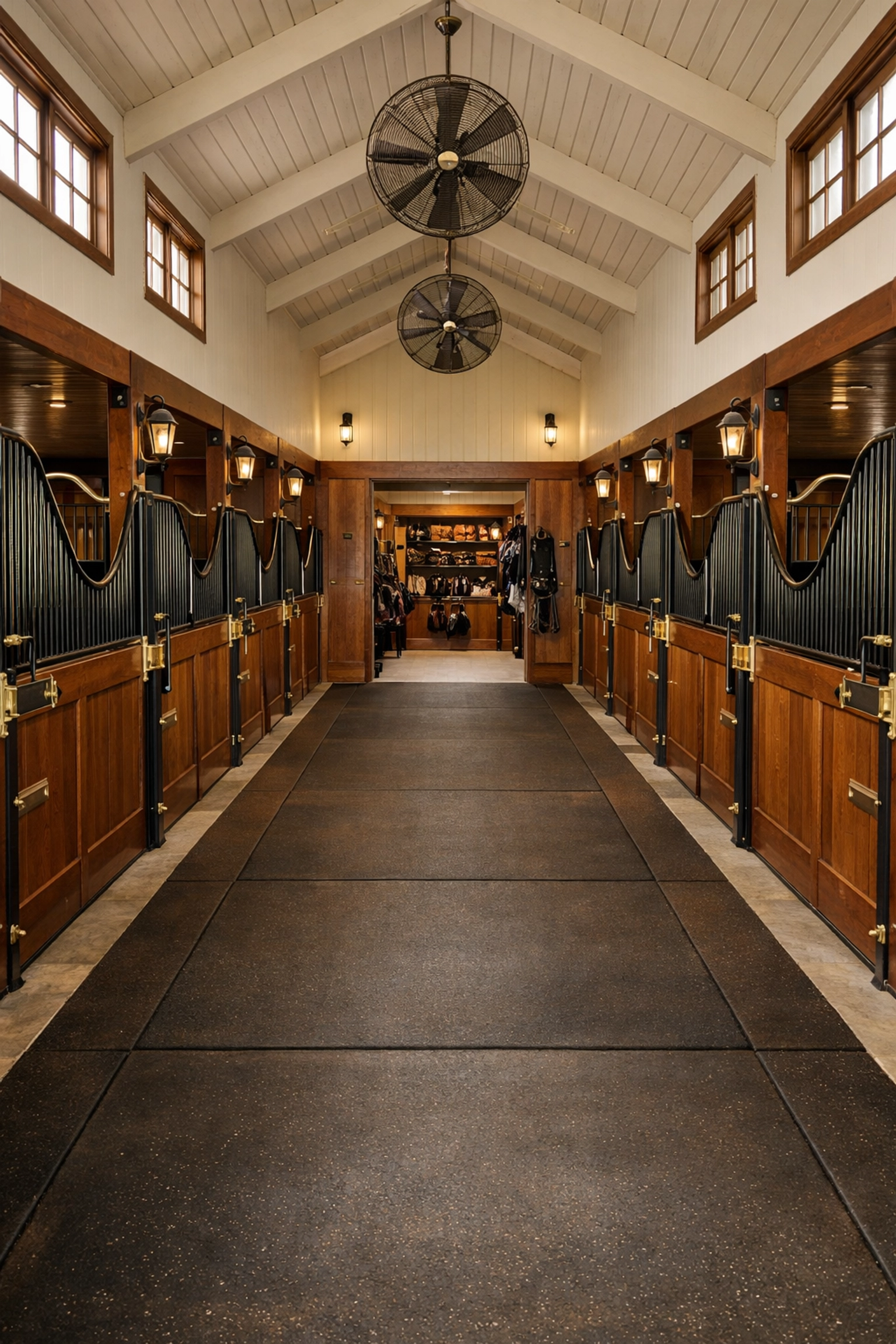 Professional horse barn interior with center aisle and stalls at Waxhaw equestrian property