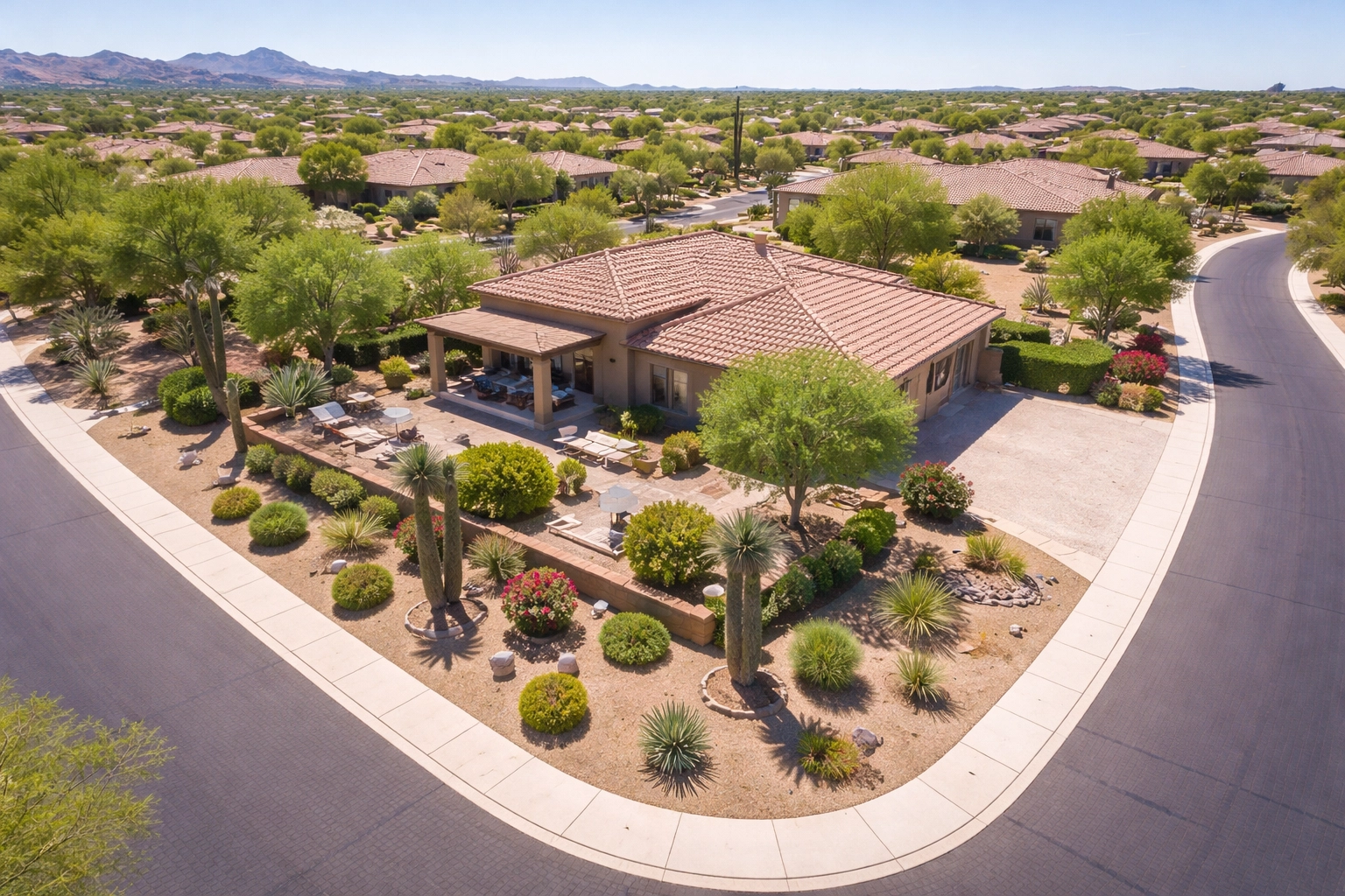 Aerial view of spacious corner lot home in a Buckeye desert neighborhood, highlighting extra yard space and privacy.