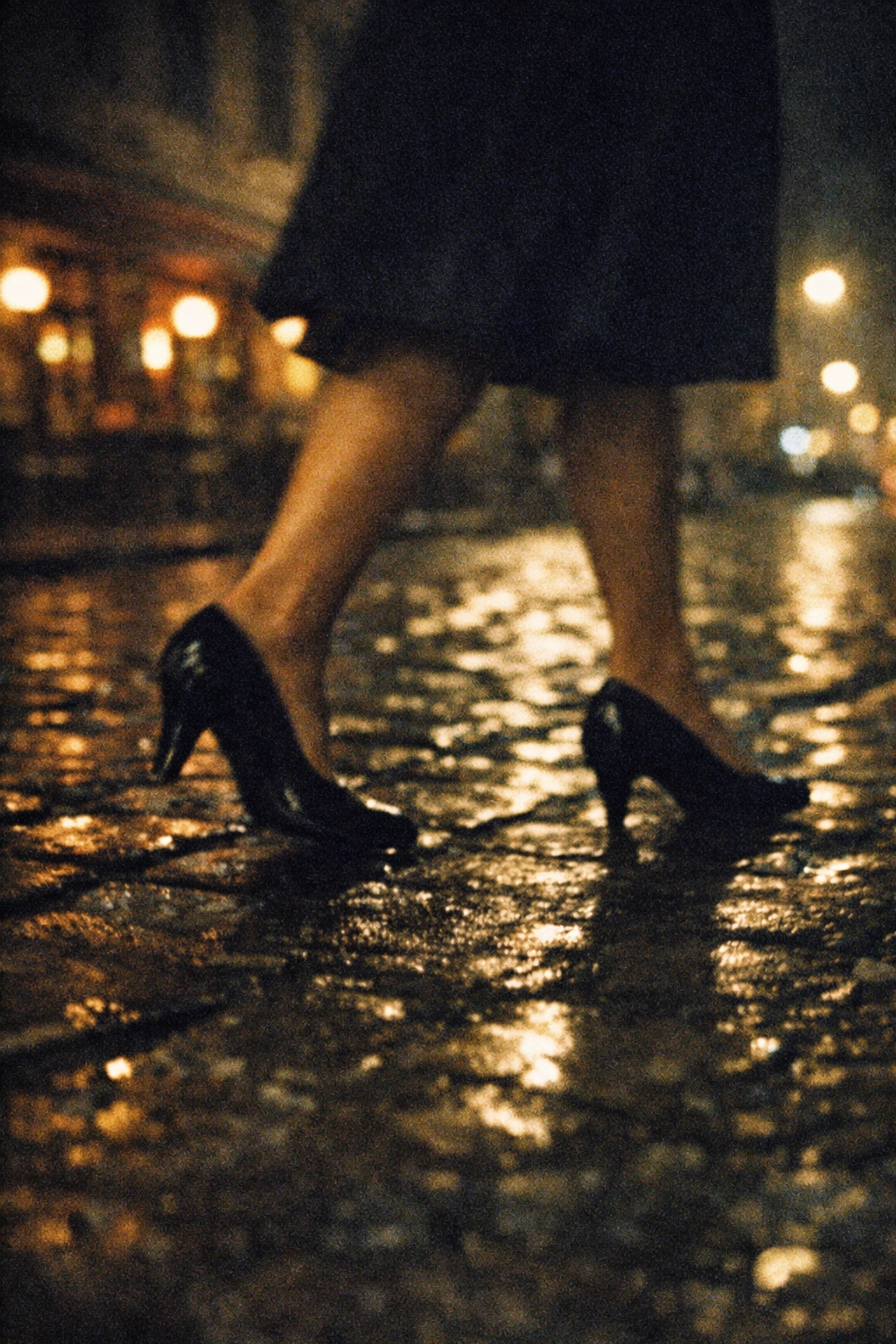 Black heels walking cobblestone Berlin street at night during crossdressing experience