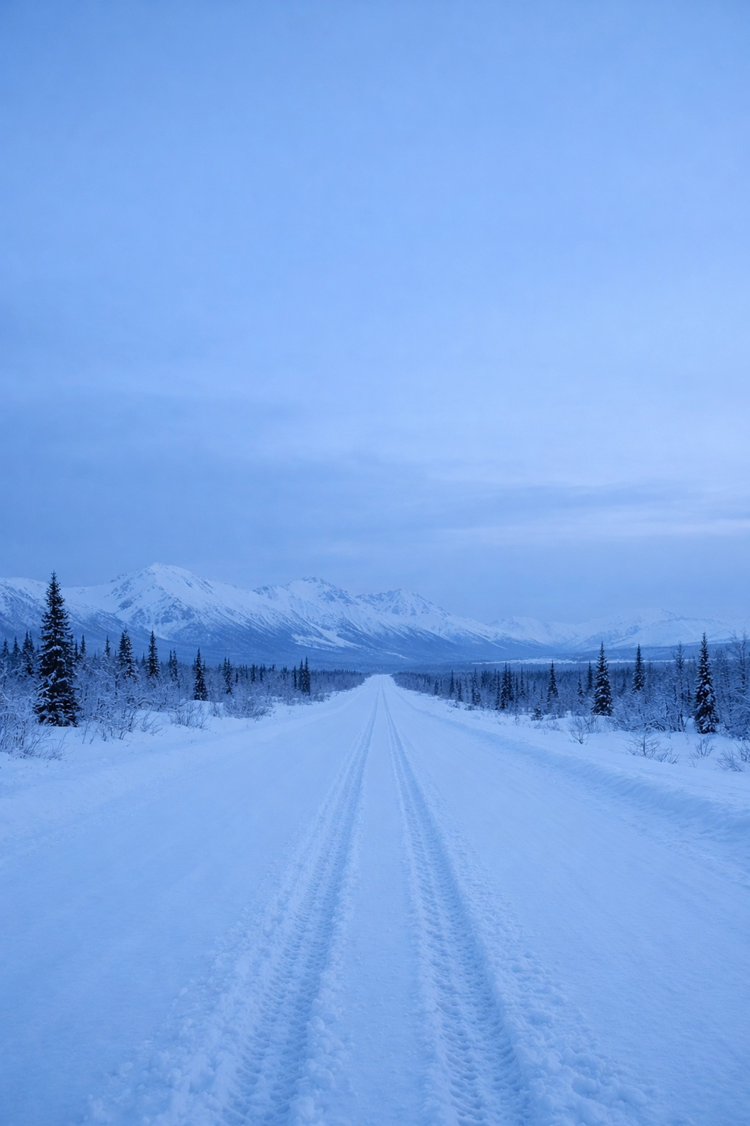 Snow-covered Alaska road showing mobile notary travel distance in winter