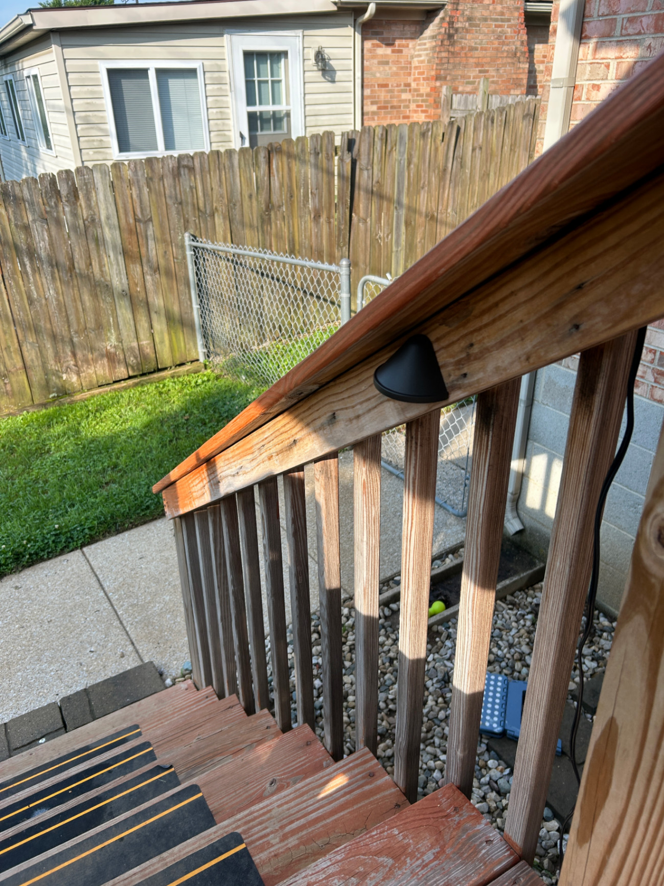 Custom low-voltage step lighting on wooden handrail