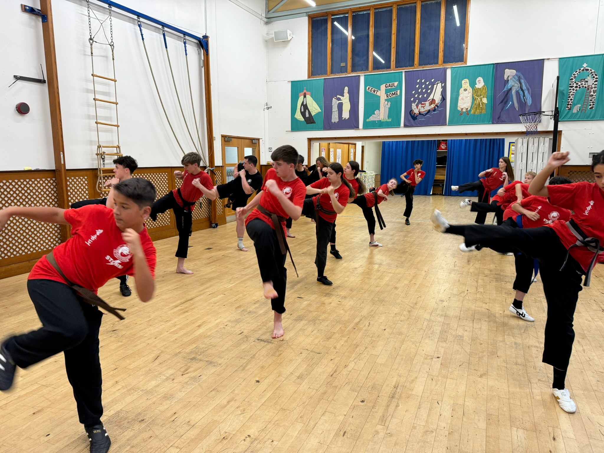 Teens martial arts class practicing kicks