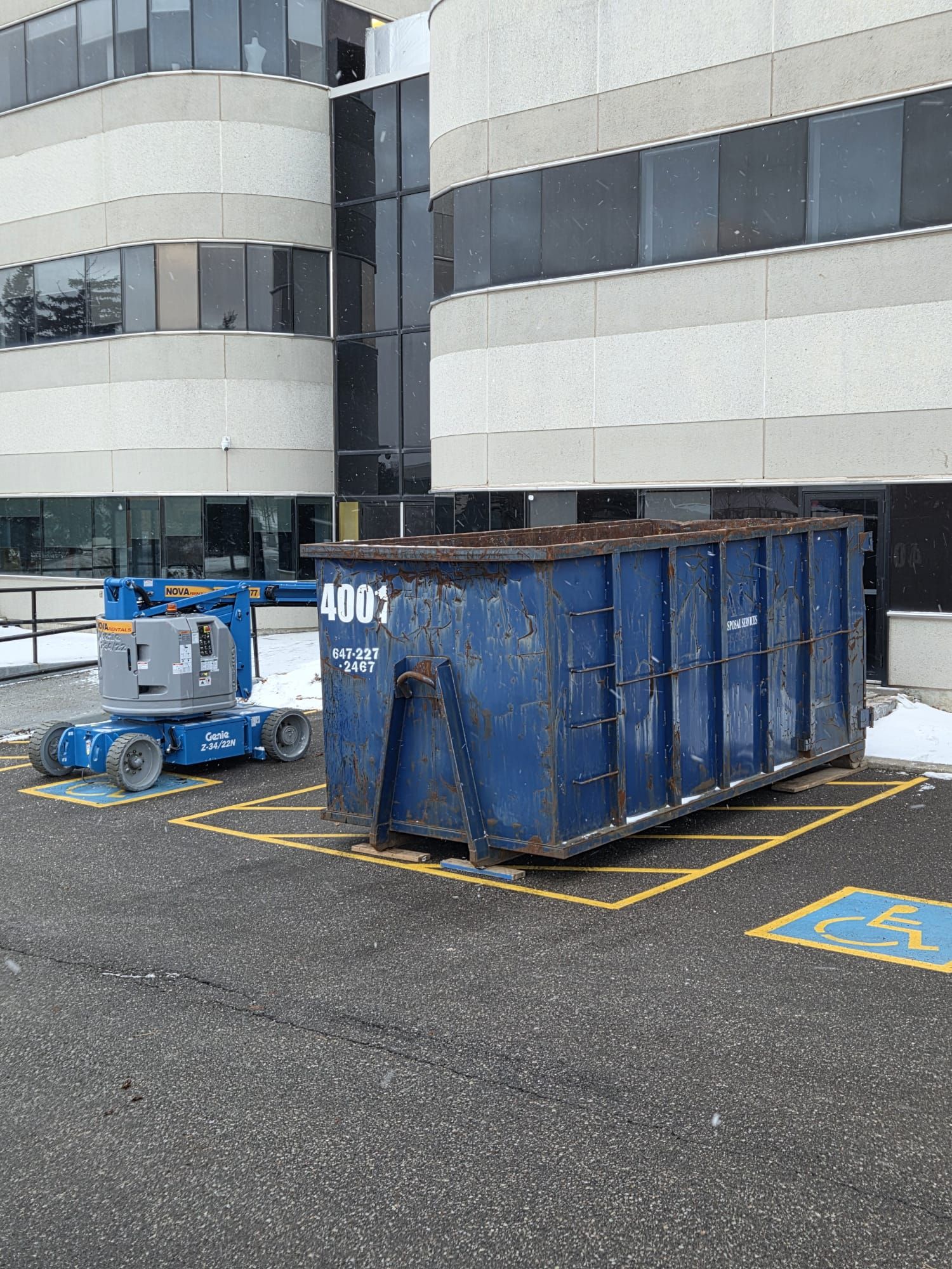 Blue roll-off dumpster outside a commercial building in North York