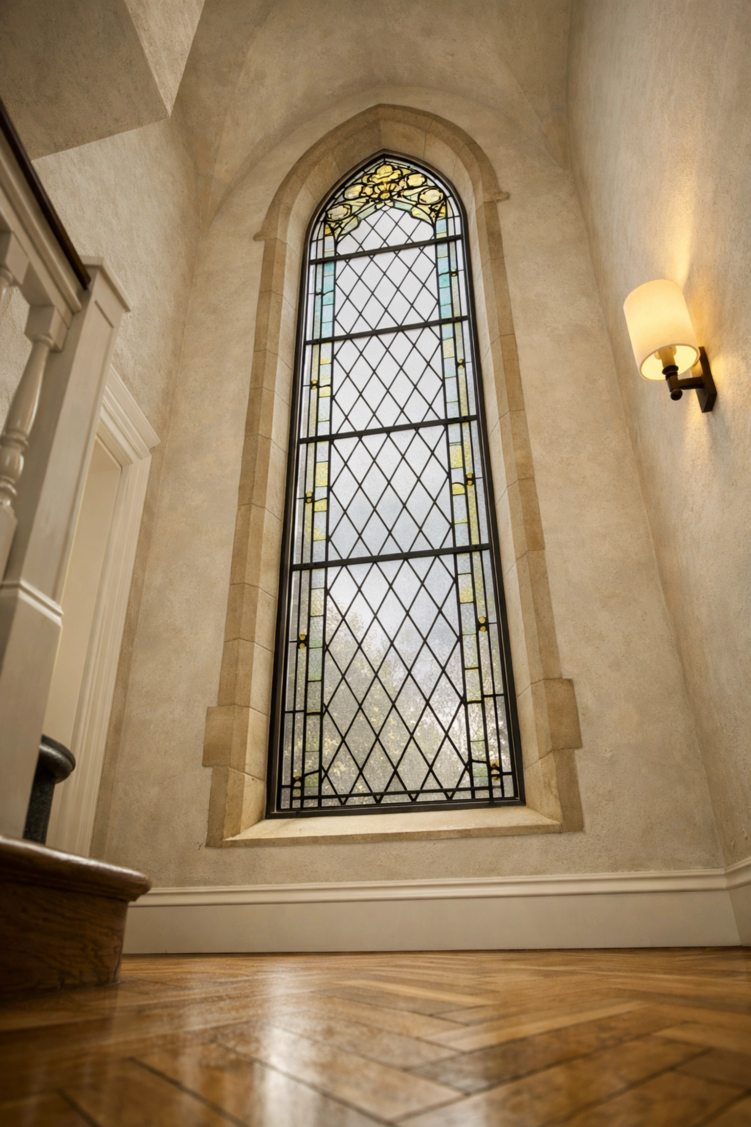 Bespoke secondary glazing fitted to a tall arched window in a modern period property hallway.