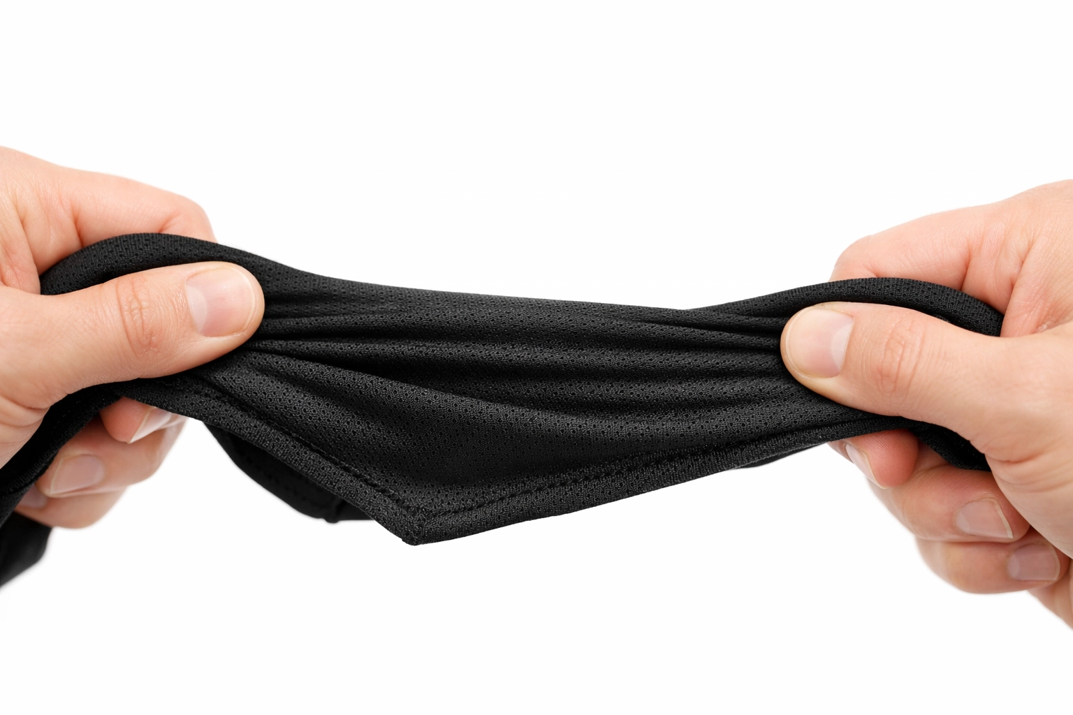 Hands testing tactical fitness gear fabric durability and performance quality