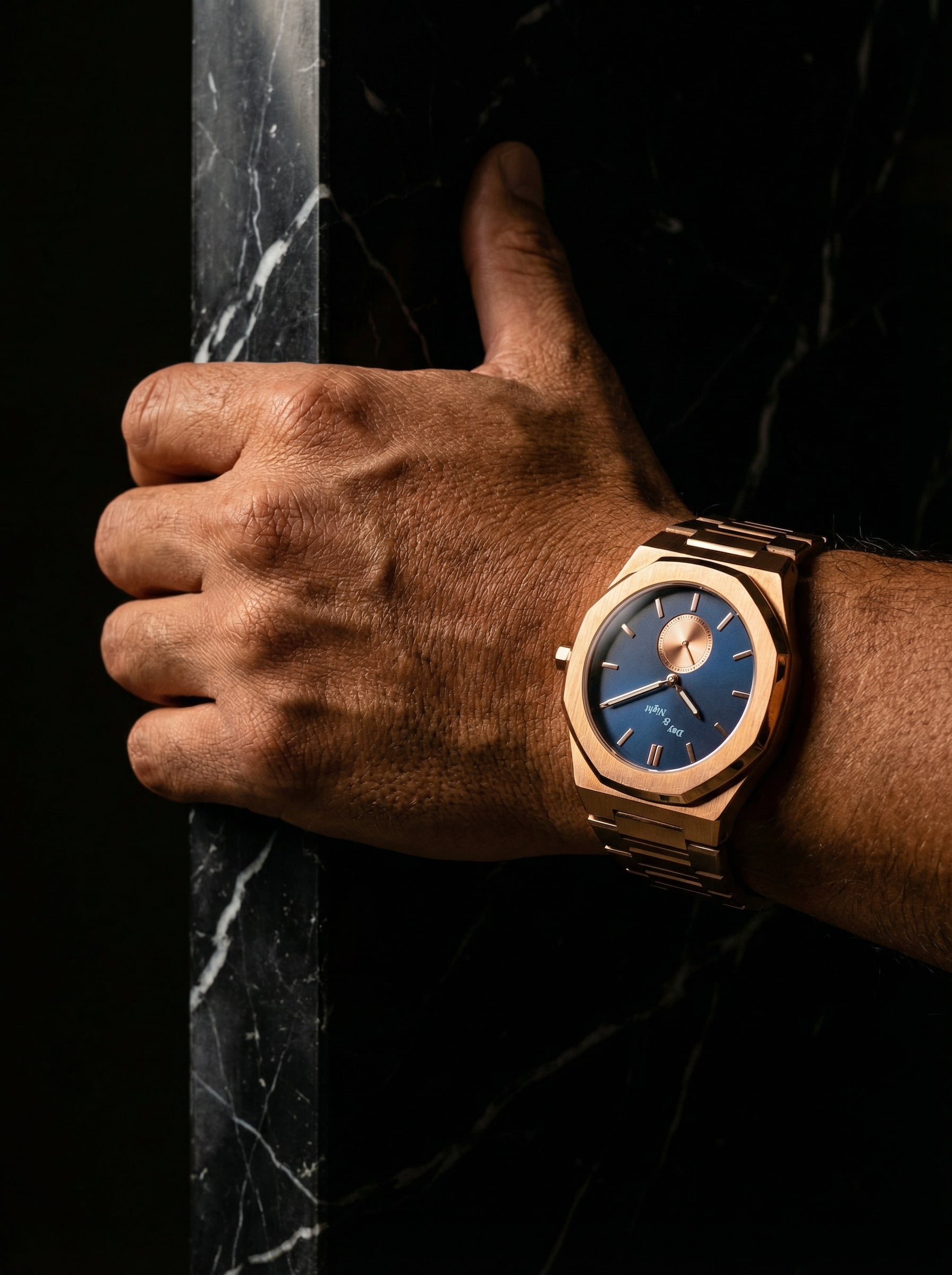 Gold-toned watch on marble