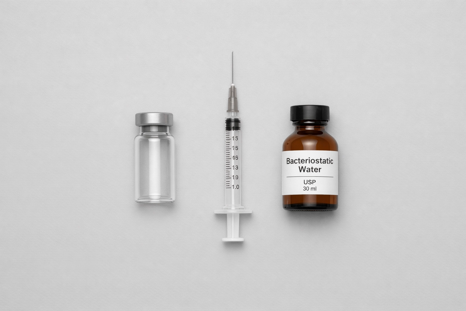 Professional flat lay of research peptide vial, syringe, and bacteriostatic water for weight loss.