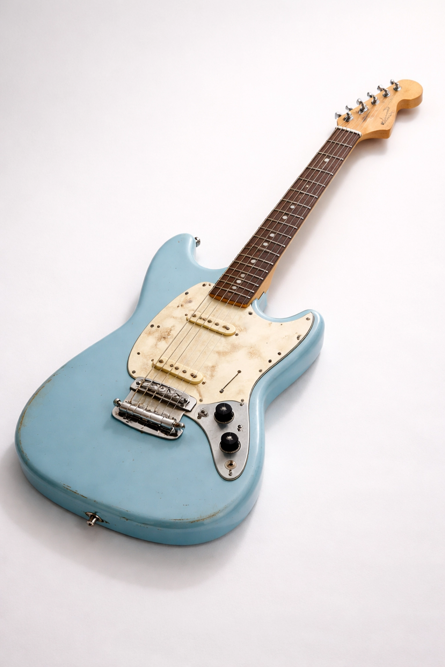 Vintage Fender Mustang electric guitar in blue, famous as Kurt Cobain’s stage guitar, displayed on white background